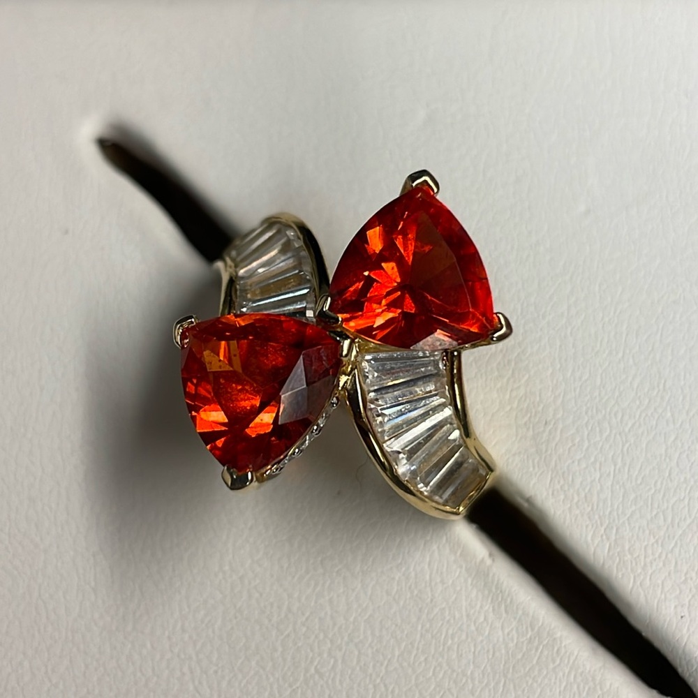 Triangle Orange faceted sapphire and gold tone ring surrounded by baguettes. 7